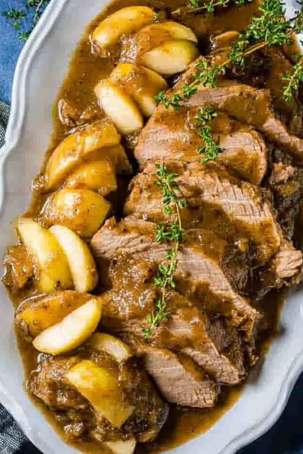 Slow cooker pork tenderloin with roasted apples, thyme, and caramelized glaze.